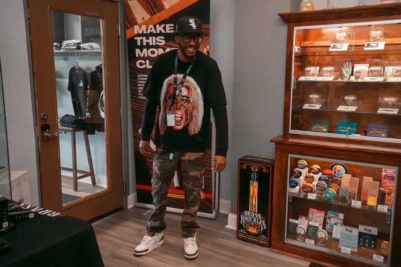 Team member standing beside the wooden display cases