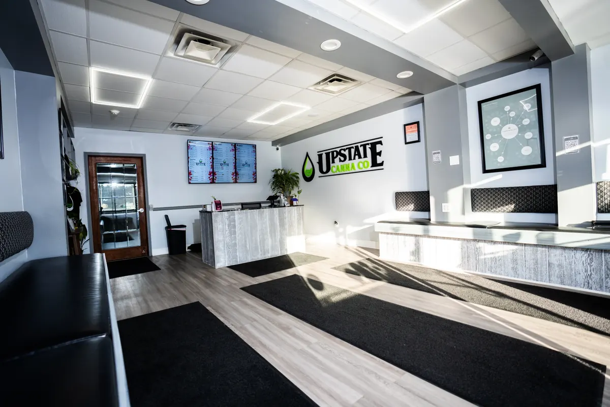 The open Upstate Canna Co. sales floor with display counter and menu screens