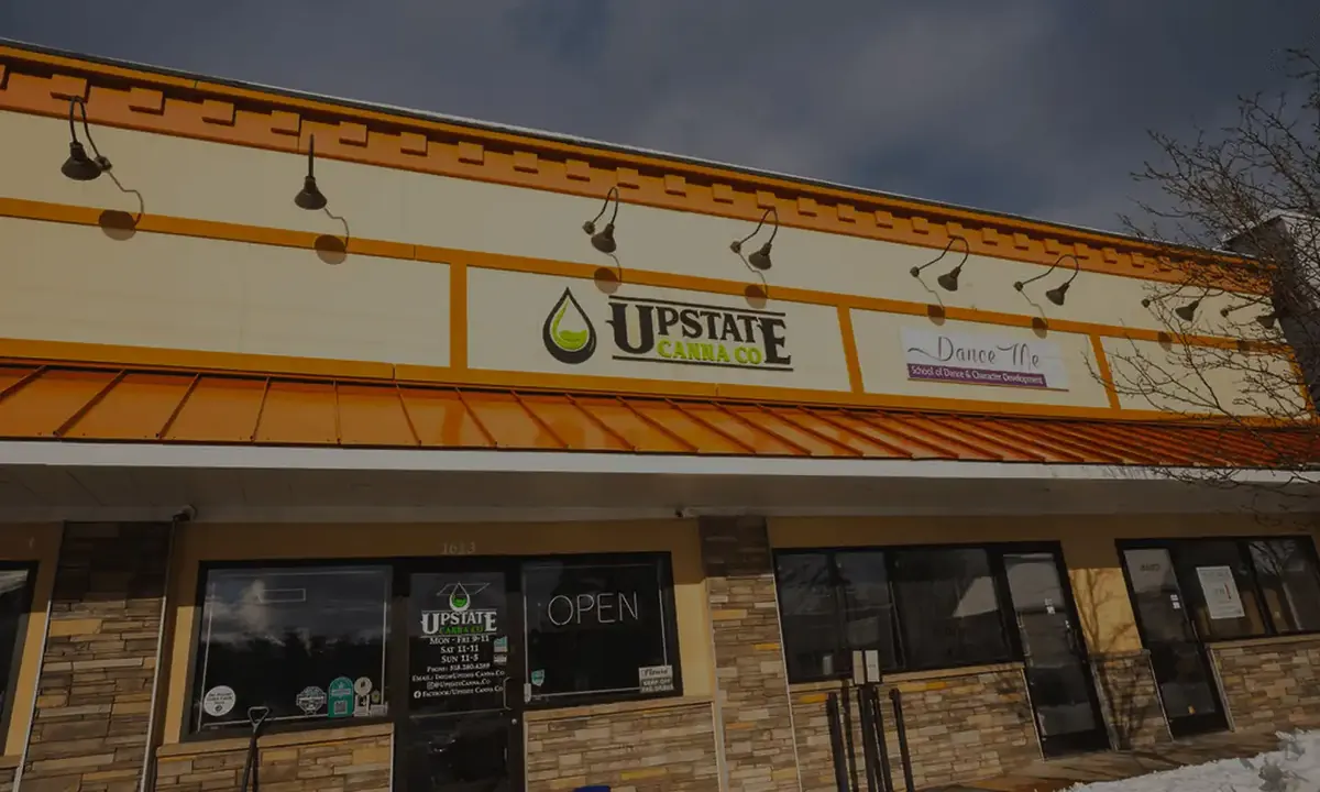 Upstate Canna Co. storefront at 1613 Union Street, Schenectady, with the open sign lit